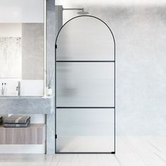 a white bathroom with a glass shower door