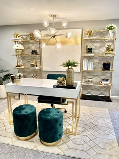 a white table with two blue stools on it in front of a mirror and shelves