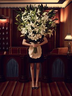 a woman holding a bouquet of flowers in her hands