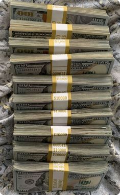 several stacks of money sitting on top of a pile of carpeted floor next to each other