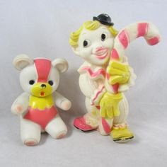 two toy figurines, one in pink and the other in white with yellow accents