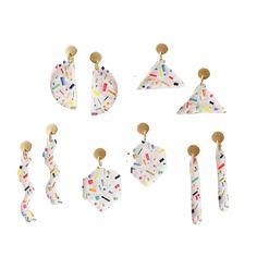 six pairs of white and multicolored geometric earrings with gold posts on each earring