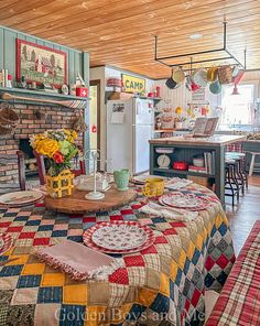 a kitchen with a table covered in plates and placemats next to a stove