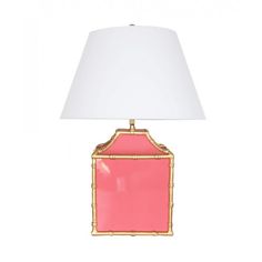 a pink and gold lamp with a white shade on the top, against a white background