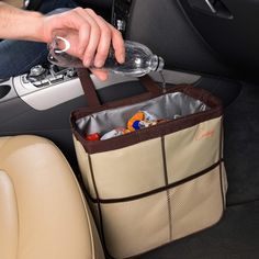 a person holding a wine glass in their hand while sitting in the back seat of a car