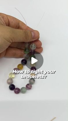 a person is making bracelets out of beads with the words how to light your bracelet?