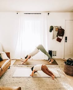 two people doing yoga on their stomachs in front of a window with the caption