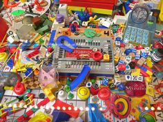 a bunch of toys that are laying on the ground in front of some lights and magnets