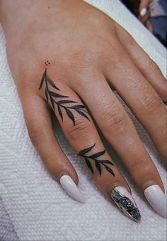 a woman's hand with some tattoos on it