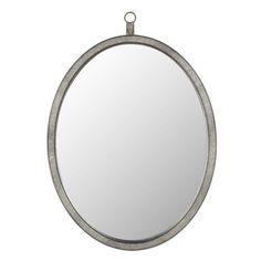 a round mirror hanging on the wall with a metal ring around it's edge