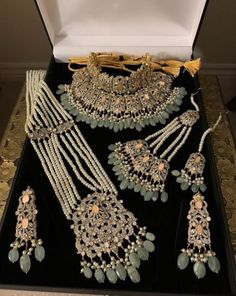 an assortment of jewelry is displayed in a box