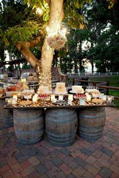 an image of a table with food on it and some wine barrels in the foreground