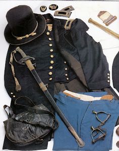 an assortment of clothing and accessories laid out on a white surface with one man's hat