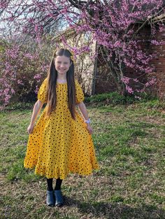 "Here is a girls simple floral peasant dress. This handmade dress is made with 100% cotton fabric. The fabric has a pretty golden yellow background with yellow and brown sunflowers all over it. This peasant style dress has an elastic neckline and empire waistline and a full flared skirt with a bottom ruffle. It is dressy enough for church or special occasions, but simple enough that it could just be an everyday play dress. The elbow length short sleeves make this dress perfect for warm weather, Yellow Cotton Dress With Ruffle Hem, Modest Shorts, Full Flared Skirt, Peasant Style Dress, Empire Waistline, Handmade Dress, Ruffled Skirt, Peasant Style, Yellow Sunflower