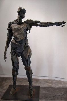 a sculpture of a man with his arms outstretched