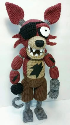 a crocheted stuffed animal that looks like a ratty with an electric bolt on it's chest