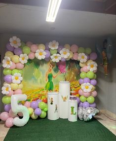 balloons and decorations are displayed in front of a backdrop