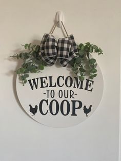 a welcome to our coop sign hanging on the wall