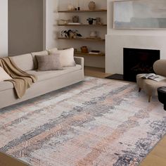 a living room with a large rug on the floor and a fire place in the corner