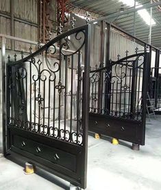 an iron gate is shown in the middle of a warehouse floor with other metal gates