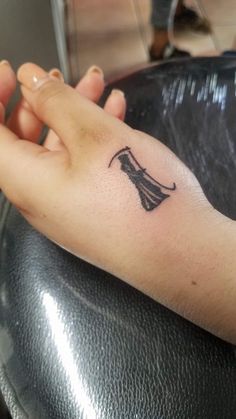 a woman's hand with a small tattoo on it