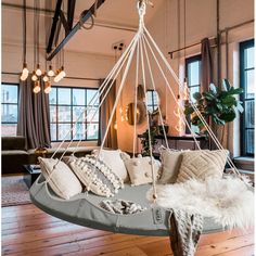 a hammock hanging from the ceiling in a living room