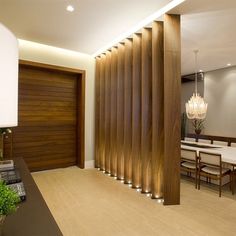 a modern dining room with wooden slatted walls