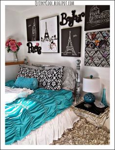 a bed room with a neatly made bed and pictures on the wall