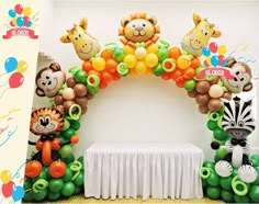 the balloon arch is decorated with animals and balloons