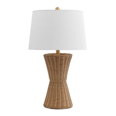 a wicker table lamp with a white shade