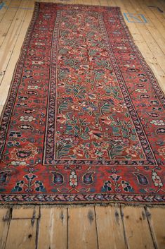 an old rug is laying on the floor in a room with wooden floors and walls