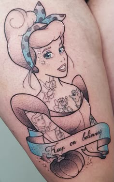 a woman's thigh with an image of princess aurora on it and the words keep on believing