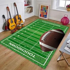 a football field rug with the name london on it and guitars in the corner next to it