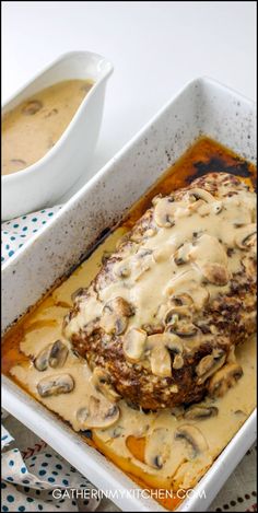 meatloaf with mushroom sauce and gravy in a white casserole dish