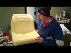 a woman is holding a large yellow chair