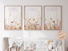 a baby's room with three posters on the wall