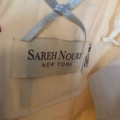 a label on the back of a white shirt that says, sareh nouri new york