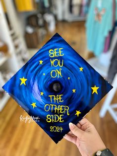 someone is holding up a graduation cap with the words see you on the other side