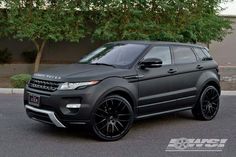 a black range rover parked in front of a building