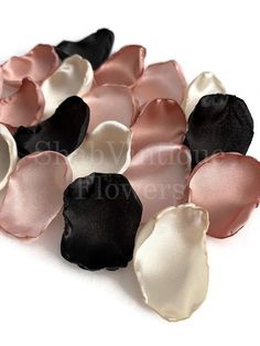 small black and pink flower petals on white background