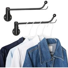 three clothes hangers and two jackets hanging on hooks