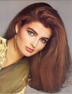 a woman with long red hair posing for a photo