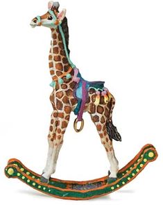 a giraffe figurine on a wooden sleigh with colorful decorations