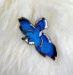 "A part of the songbird series for the 'Sky of Jewels' hard enamel pin series first found on Kickstarter, this Blue Jay hard enamel pin is a celebration of the beauty of the songbirds that are found in so many of our backyards!  2.80\" wide from wingtip to wingtip Nickel Black Finish Backer Card Two Clutches (Your choice!) Rubber Clutches: Good for hats, clothes, or any time a metal back might irritate your skin. Butterfly Metal Clutches: Good for bags, collars, and pin boards. Locking Clutch: G Bird Enamel Pin, Bird Accessories, Animal Pins, Pin Boards, Backpack Pins, Bird Pins, Magical Jewelry, Pin Art, Cool Pins