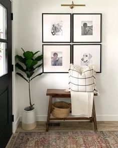 a white room with pictures on the wall and a wooden bench in front of it