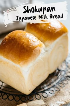 two pieces of bread sitting on top of a wire rack with the words shoupan japanese milk bread