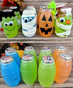 there are many halloween soda bottles with faces on them