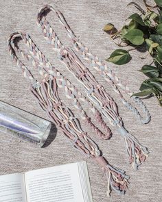 an open book sitting on top of a table next to a bunch of rope and a bottle