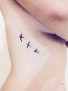 three birds on the side of a woman's neck