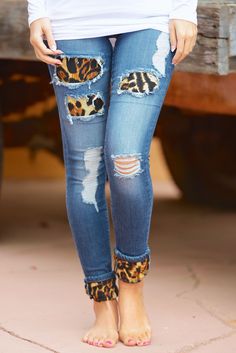 a woman in ripped jeans with leopard print on the side